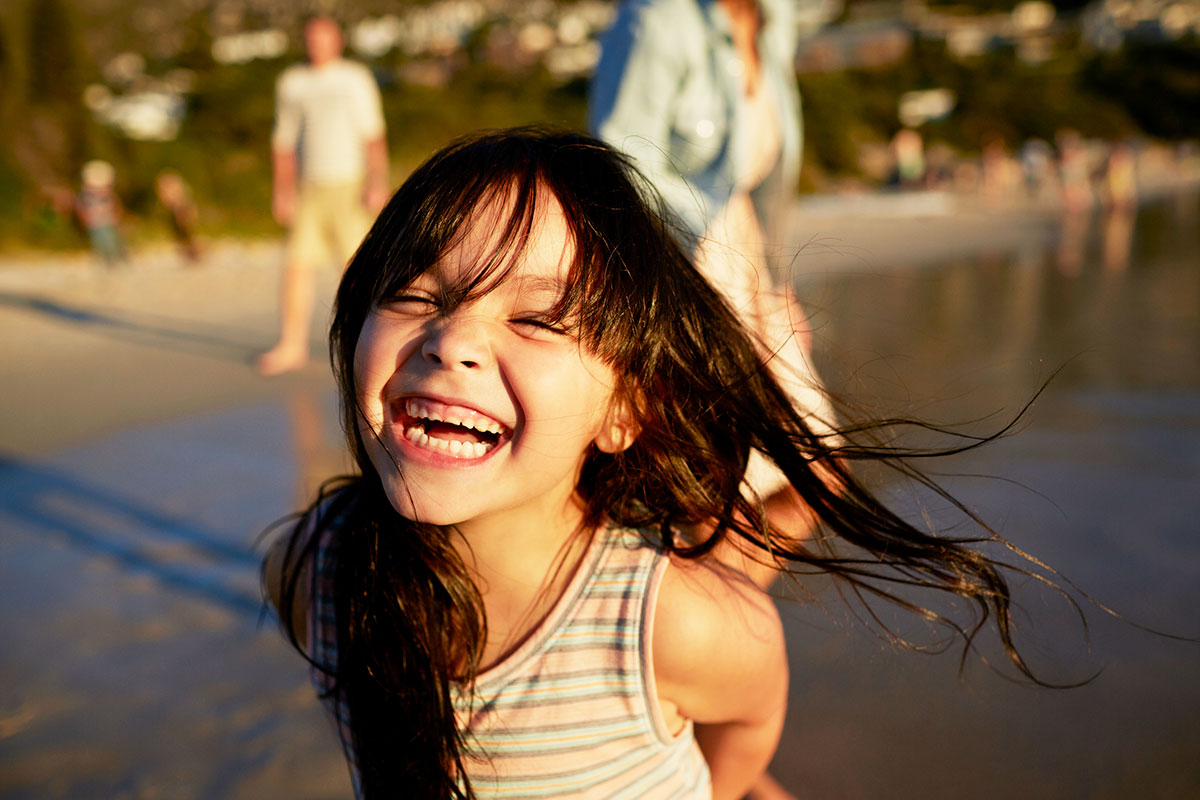 GirlOnBeachLaughing