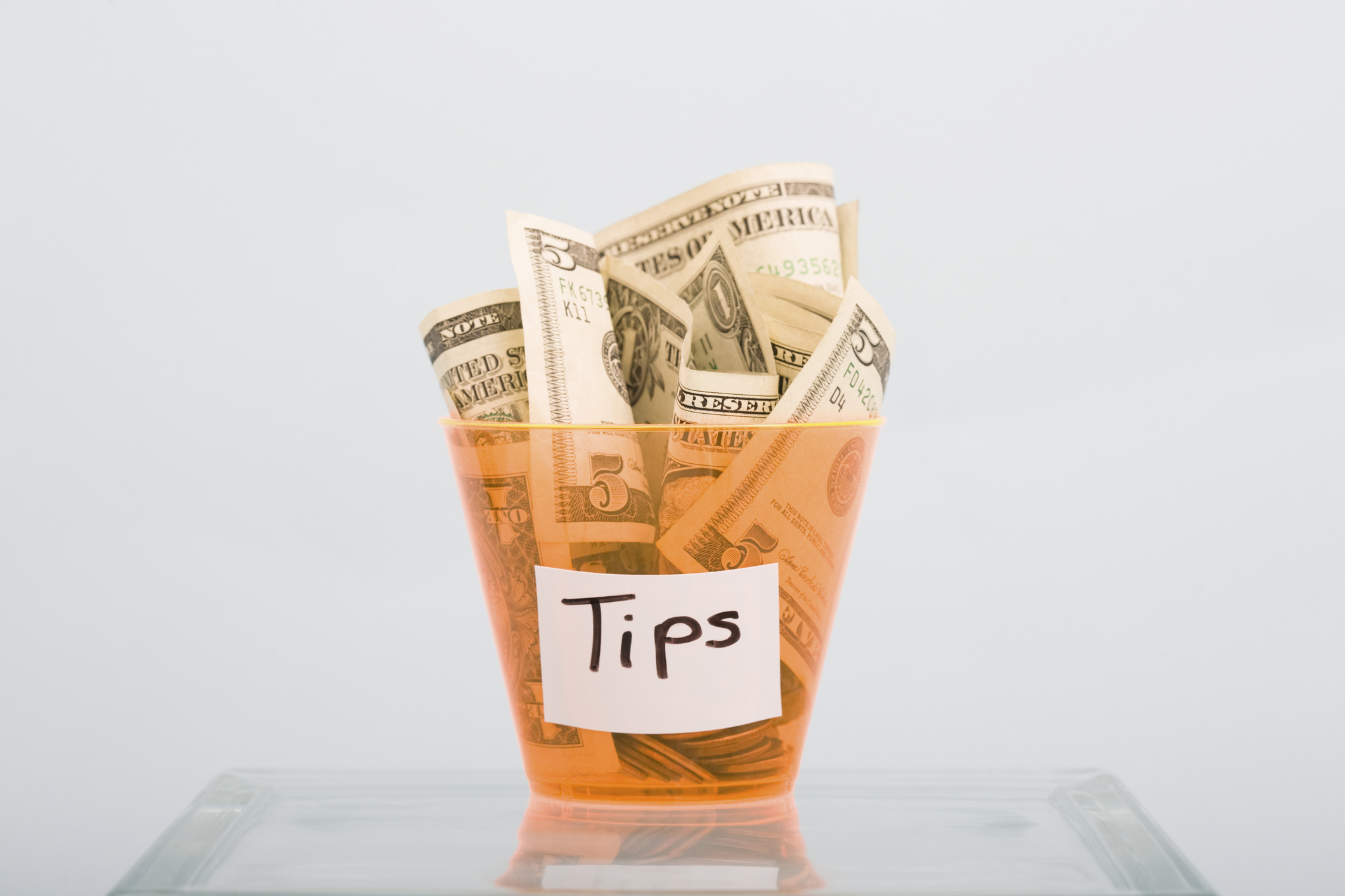 Tips in an orange tip glass