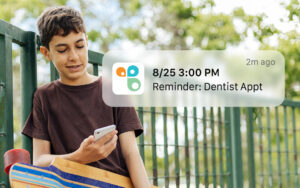 Child on phone getting a reminder from Cozi