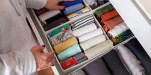 kids' rolled up t-shirts neatly organized in a pullout dresser drawer